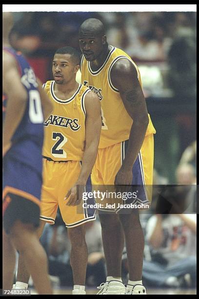 Los Angeles Lakers center Shaquille O''Neal and guard Derek Fisher look on during a game against the Phoenix Suns at the Great Western Forum in...