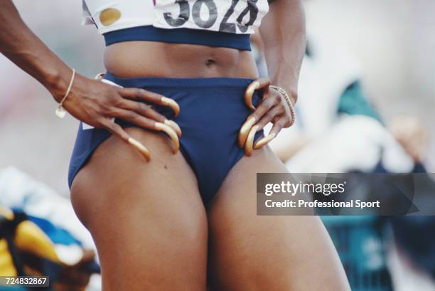 Close up view of the exceptionally long painted fingernails of United States track athlete Gail Devers as she prepares to compete in the Women's 100...