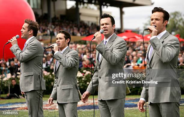 Andrew Tierney, Phil Burton, Michael Tierney and Toby Allen of Human Nature sing the national anthem before the start of The Emirates Melbourne Cup...