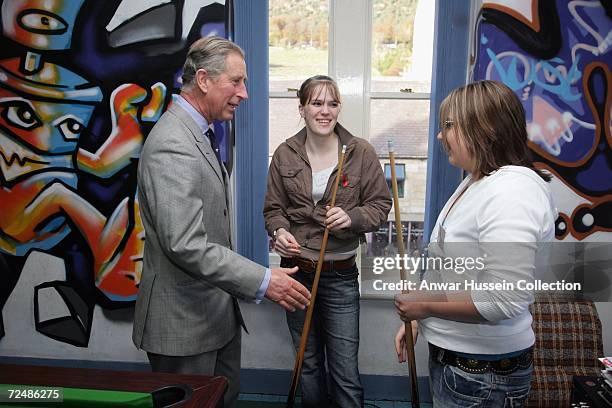 Prince Charles, Prince of Wales plays pool with teenagers on November 9, 2006 as he visits the Jubilee Institute at Rothbury, England.