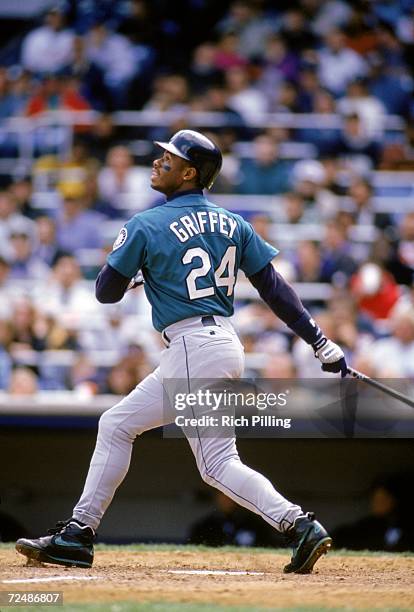 Ken Griffey, Jr. #24 of the Seattle Mariners watches the flight of the ball as he follows through on his swing during a 1994 MLB season game. Ken...