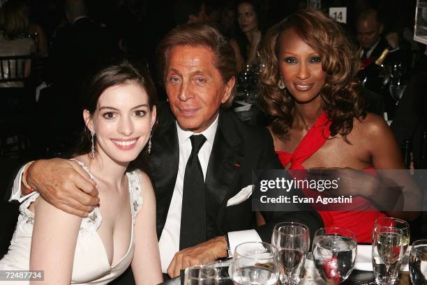 Actress Anne Hathaway, designer Valentino Garavani and model Iman pose for a photo at "The Black Ball" presented by Conde Nast Media Group and hosted...
