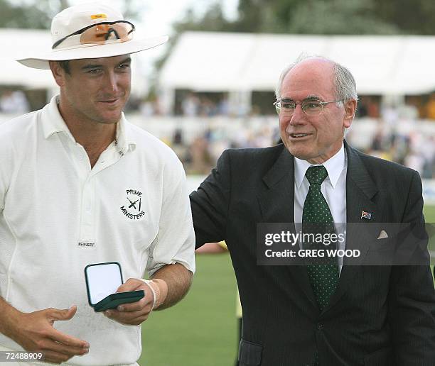 Australian Prime Minister John Howard presents Man-of the Match Australia's Phil Jaques with his award following the match between England and the...