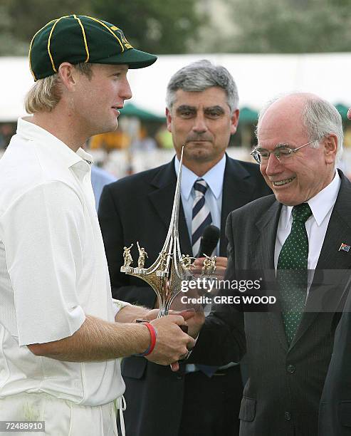 Australian Prime Minister John Howard presents Australian captain Cameron White with the winners trophy following the match between England and the...