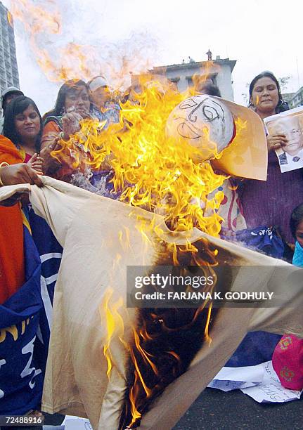 Bangladeshi activists from the youth wing of Awami League set fire to an effigy of chief election commissioner M. A. Aziz during a human chain...