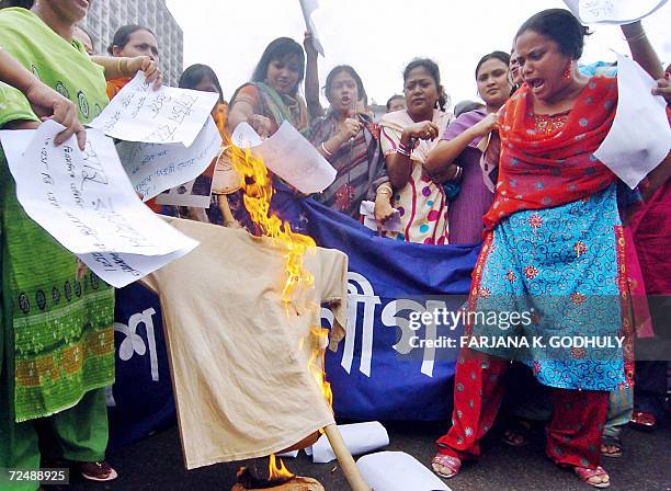 Bangladeshi activists from the youth wing of Awami League set fire to an effigy of chief election commissioner M. A. Aziz during a human chain...