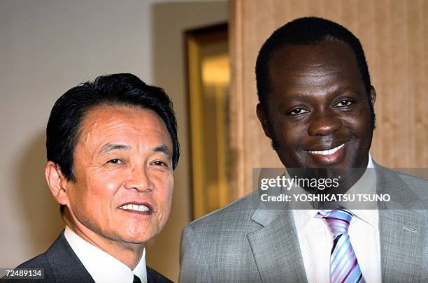 Visiting Kenyan Foreign Minister Ruphael Tuju is greeted by his Japanese counterpart Taro Aso for their talks at Aso's office in 10 November 2006....