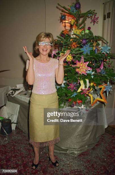 British television presenter Anthea Turner tries on a pair of novelty glasses at the Hurlingham Club for the Haven Trust Christmas Tree Auction, 2nd...