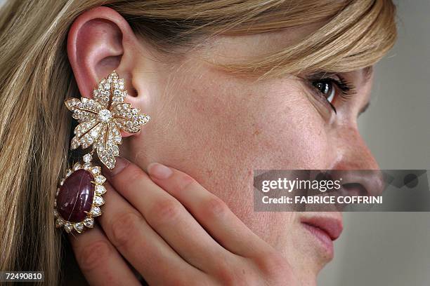 Christie's employee displays a pair of ear clips formely belonging to Jacqueline Kennedy Onassis, which she received in 1968 as a wedding gift from...