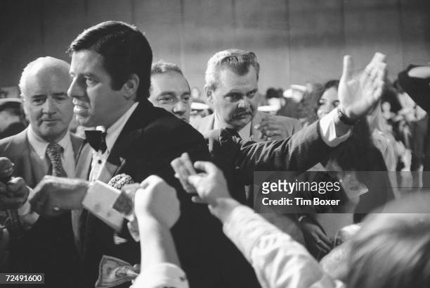 American comedian and actor Jerry Lewis walks among audience members who reach out and offer him money during his annual charity event to raise money...