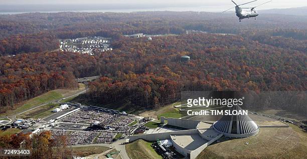 Quantico, UNITED STATES: As a Marine helicopter flies over, hundreds of invited guest await the arrival of US President George W. Bush for the...