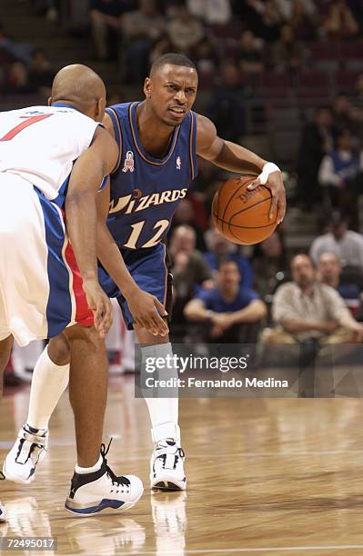 Chris Whitney of the Washington Wizards with the ball against Chucky Atkins of the Detroit Pistons during their game at the Palace of Auburn Hills in...