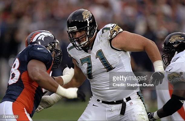 Tony Boselli of the Jacksonville Jaguars pushes Maa Tanuvasa of the Denver Broncos at Mile High Stadium in Denver, Colorado. The Broncos defeated the...