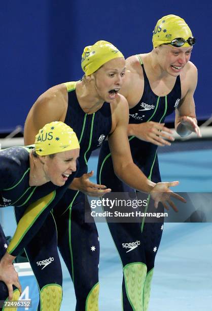 Australian team members Petria Thomas, Lisbeth Lenton and Alice Mills cheer on their teammate Jodie Henry on their way to winning gold in the women's...