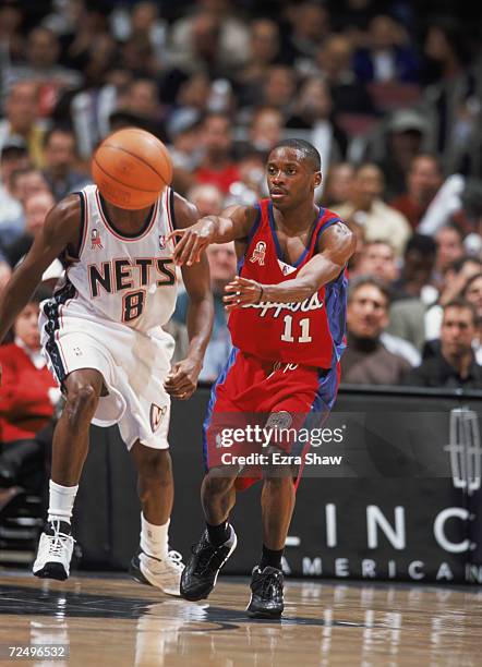 Point guard Earl Boykins of the Los Angeles Clippers passes the ball as point guard Anthony Johnson of the New Jersey Nets plays defenes during the...