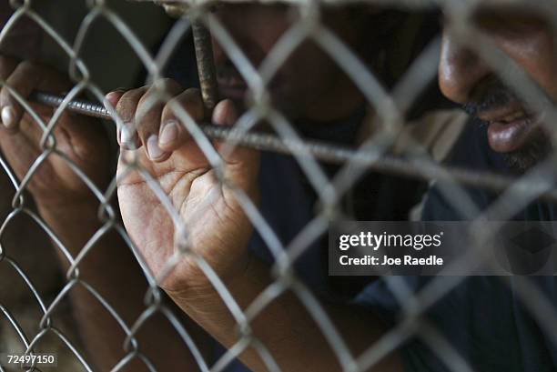 Prisoners wait in a cell to be processed for release from Abu Ghraib prison on July 15, 2004 west of Baghdad, Iraq. The U.S. Army released 65...