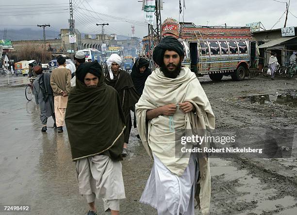 Afghan Taliban walk through one of the main bazaars February 25, 2005 in Quetta, Pakistan. Taliban forces have been taking refuge inside the...