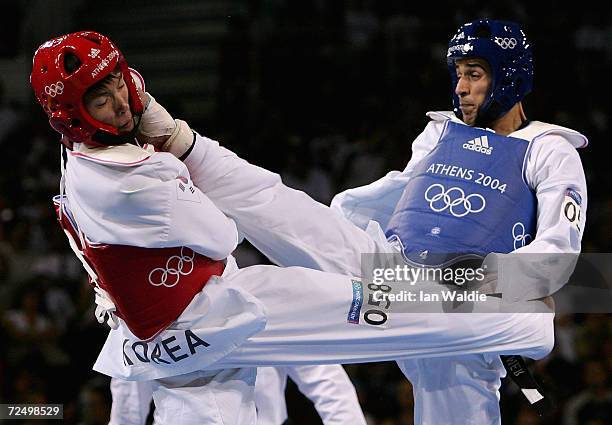 Tamer Hussein of Egypt lands a kick to the head of Myeong Seob Song of Korea in the men's under 68 kg Taekwondo repechage match on August 27, 2004...