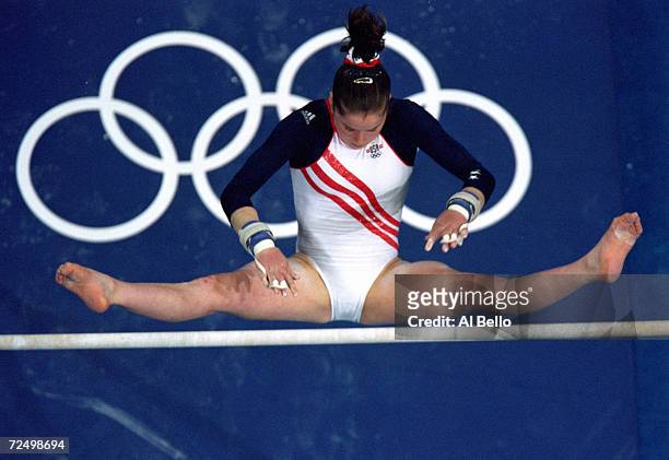 Elise Ray of the United States swings over the uneven bars during the Women's Gymnastics at the Sydney Superdome in the 2000 Olympics in Sydney,...