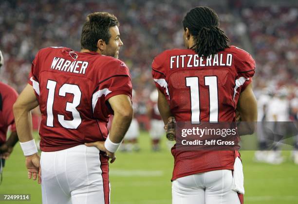 Quarterback Kurt Warner and Larry Fitzgerald of the Arizona Cardinals talk on the sidelines during the game against the Denver Broncos on August 31,...
