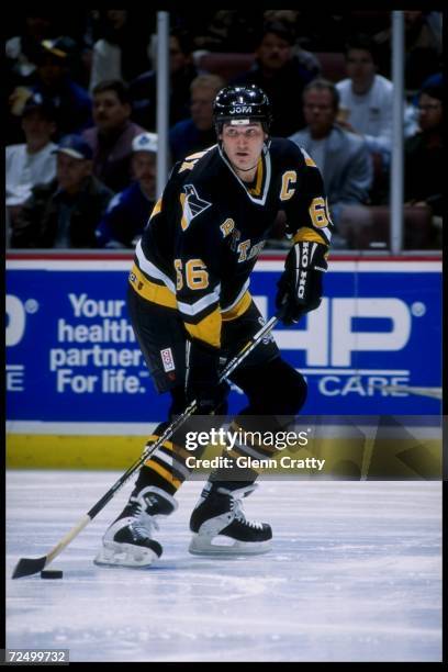 Center Mario Lemieux of the Pittsburgh Penguins moves the puck during a game against the Anaheim Mighty Ducks at Arrowhead Pond in Anaheim,...