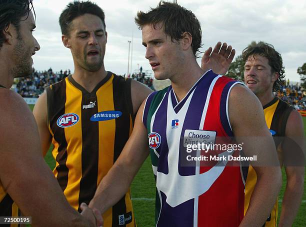 Hawthorn players Ben Dixon, Jade Rawlings and Kris Barlow congratulate former teammate Trent Croad, now for Fremantle, during the Round 3 AFL match...