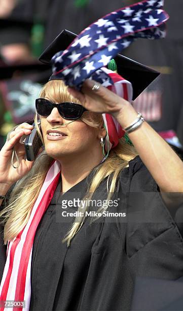 An unidentified graduate waves a flag at the Ohio State University Spring commencement June 14, 2002 in Columbus, Ohio. U.S. President George W. Bush...