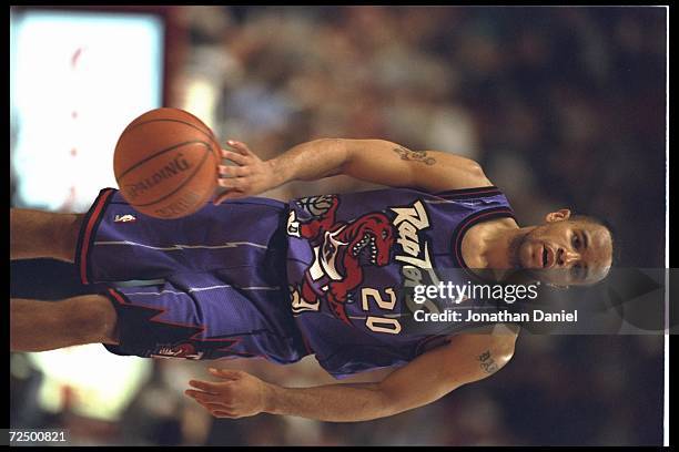 Guard Damon Stoudamire of the new expansion team Toronto Raptors dribbles down court to face the Chicago Bulls at the United Center in Chicago,...