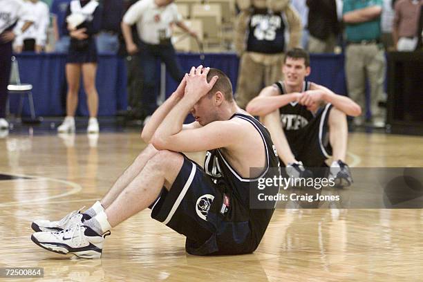 Guard Andrew Graves and center Scott Robisch of the Butler Bulldogs sit in dejection after their 69-68 overtime loss to the Florida Gators during...