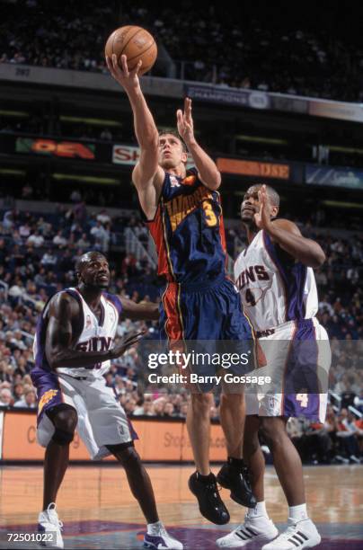 Guard Bob Sura of the Golden State Warriors shoots the ball as forward Alton Ford of the Phoenix Suns plays defense during the NBA game at the...