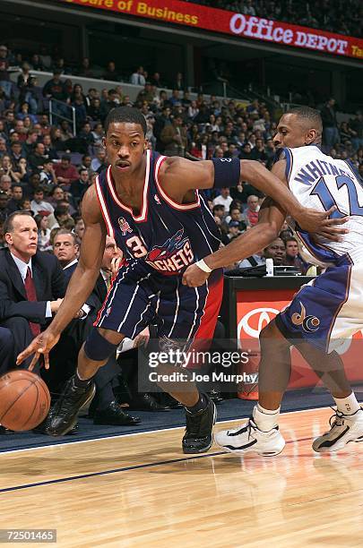 Steve Francis of the Houston Rockets drives in past Chris Whitney of the Washington Wizards during a game at the MCI Center Washington D.C. Digital...