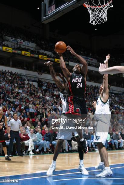 Jim Jackson of the Miami Heat goes to the basket after getting past Joe Smith of the Minnesota Timberwolves during their game at Target Center in...