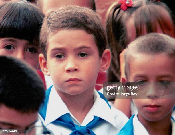 Elian Gonzalez, center,stands among his classmates during the first day of classes at the Marcelo Salado school in Cardenas, Cuba September 1, 2000....