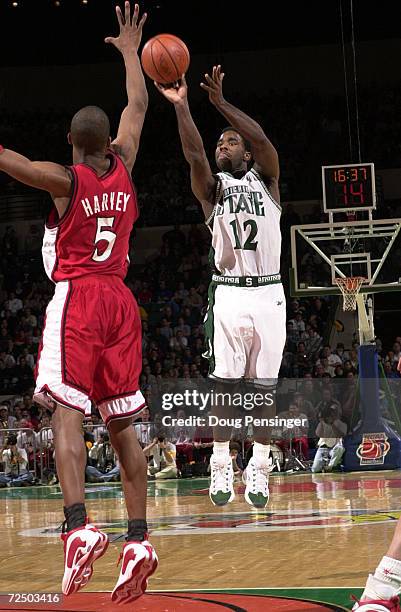 Mateen Cleaves of Michigan State University takes a shot over Tony Harvey of the University of Utah as the Spartans defeated the University of Utah...
