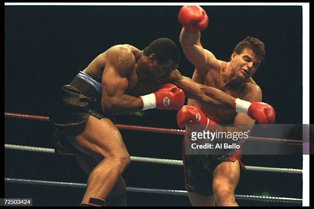 Mark Gastineau and Alonzo Highsmith trade blows during a bout at Tokyo Bay NK Hall in Tokyo, Japan. Highsmith won the fight with a TKO in the second...