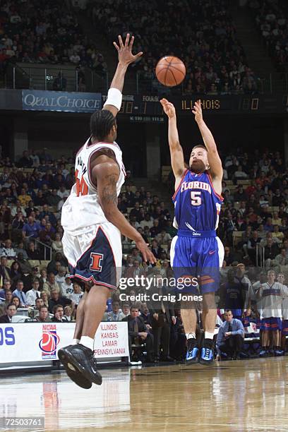 Guard Teddy Dupay of the Florida Gators shoots the ball over forward Sergio McClain of the Illinois Fighting Illini during their second round NCAA...