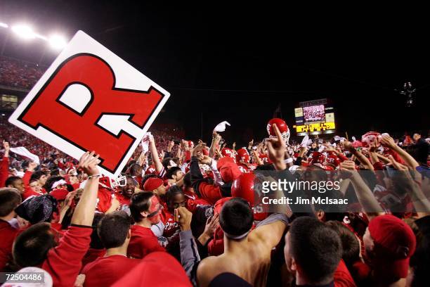 Fans of the Rutgers Scarlet Knights rush the field after their team defeated the Louisville Cardinals 28-25 at Rutgers Stadium on November 9, 2006 in...