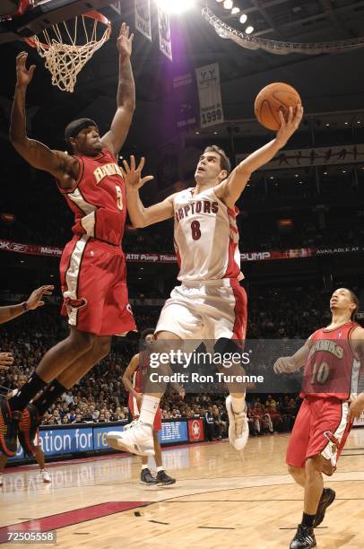 Jose Calderon of the Toronto Raptors puts up a layup against Josh Smith of the Atlanta Hawks on November 10, 2006 at the Air Canada Centre in...