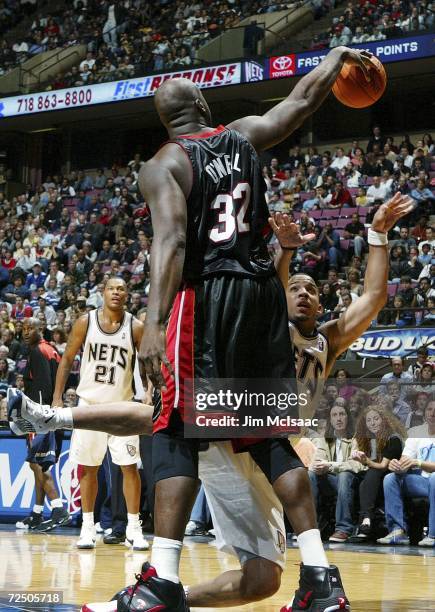 Shaquille O'Neal of the Miami Heat commits a foul against Marcus Williams of the New Jersey Nets during their game on November 10, 2006 at...