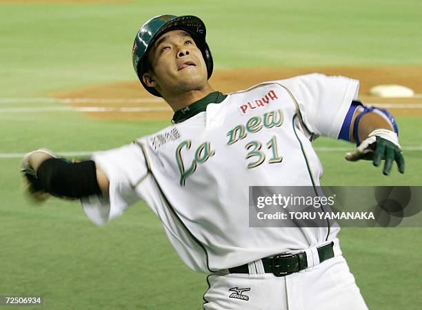 Taiwan's La New Bears infielder Lin Chih sheng throws his team's mascot stuffed bear to his fans after slamming a solo homer during the sixth inning...