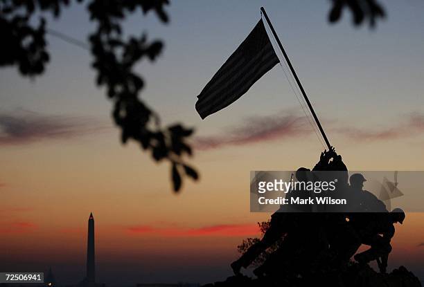 The early morning sun begins to rise behind the US Marine Corp's Iwo Jima Memorial on Veterans Day November 11, 2006 in Arlington, Virginia. Later...