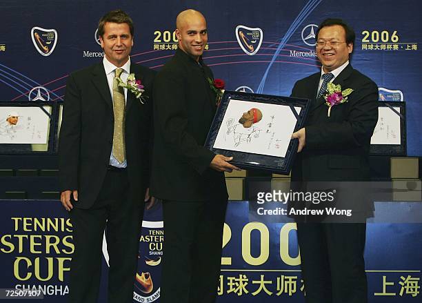 James Blake of the USA receives a souvenir from Chen Jing , Director of Minhang District of Shanghai, as Brad Drewett, Tennis Masters Cup Tournament...