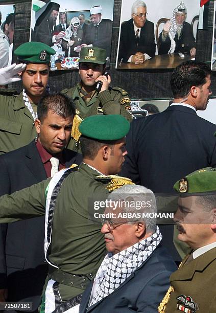 Palestinian President Mahmud Abbas , flanked by security guards, arrives at a ceremony commemorating the second anniversary of Yasser Arafat's death,...