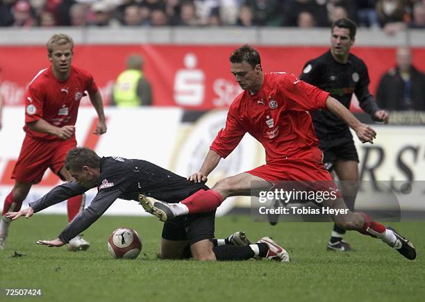 St. Pauli's Arvin Braun, left, and Henri Heeren of Dusseldorf compete for the ball during the Third League match between Fortuna Dusseldorf and FC...