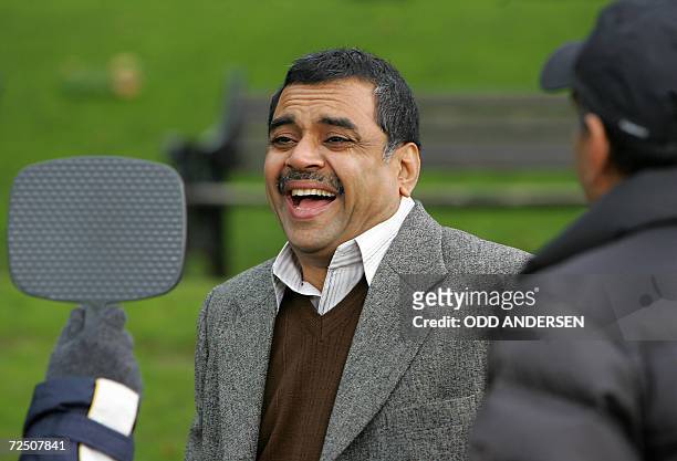 United Kingdom: Indian actor Paresh Rawal laughs at himself in a mirror watched by film director Milan Luthria while filming the Bollywood production...