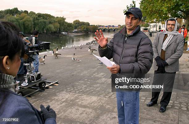 United Kingdom: Indian film director Milan Luthria insructs Indian actor Paresh Rawal and actress Asawari Joshi while filming the Bollywood...