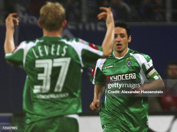 Oliver Neuville of Monchengladbach celebrates scoring the second goal with his teammate Tobias Levels during the Bundesliga match between Hamburger...