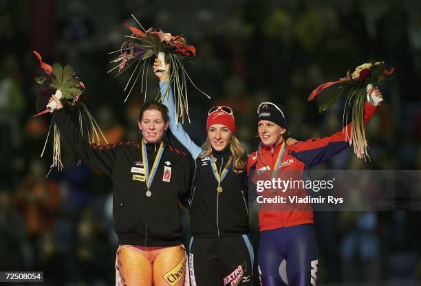 Christine Nesbitt of Canada , Anni Friesinger of Germany and Ireen Wust of Netherlands pose for a photo at the medal ceremony of the women's 1500m...