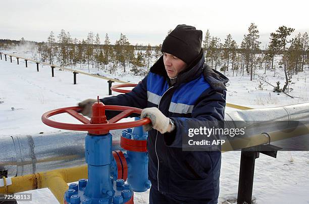 File picture taken 02 November 2006 shows a worker as he opens a valve of a gas pipeline of the Russian Gazprom enterprise in Vyngayakhinsky gas...