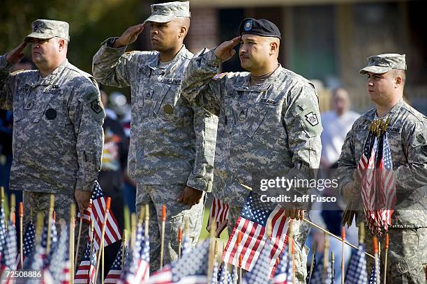 Members of the U.S. Armed Forces salute at a Veterans Day ceremony at the Prospect Hill Cemetery November 11, 2006 in York, Pennsylvania. More than...